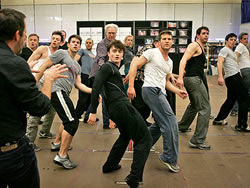 Daniel Radcliffe with John Larroquette behind him rehearsing "How to Succeed in Business without Really Trying," 2011. Photo: Ari Mintz